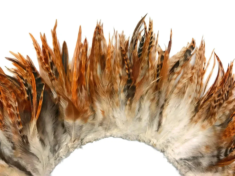 Natural brown and white patterned feathers for DIY crafts and fashion accessories.