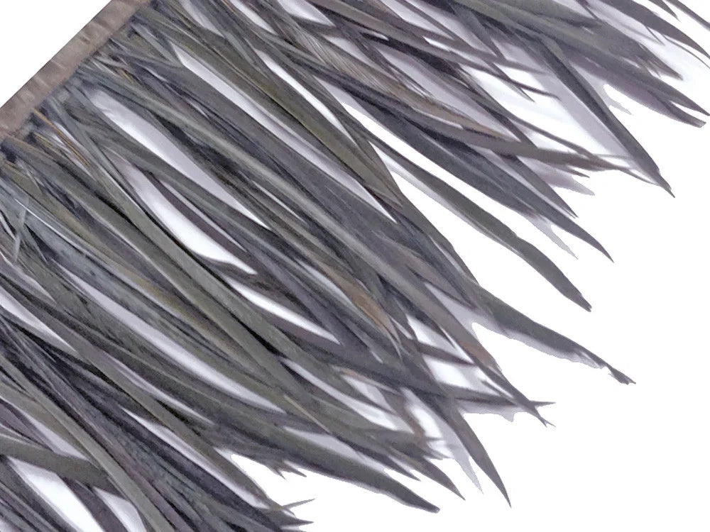 Close-up of long, pointed grey decorative feathers for fashion and craft DIY supplies.