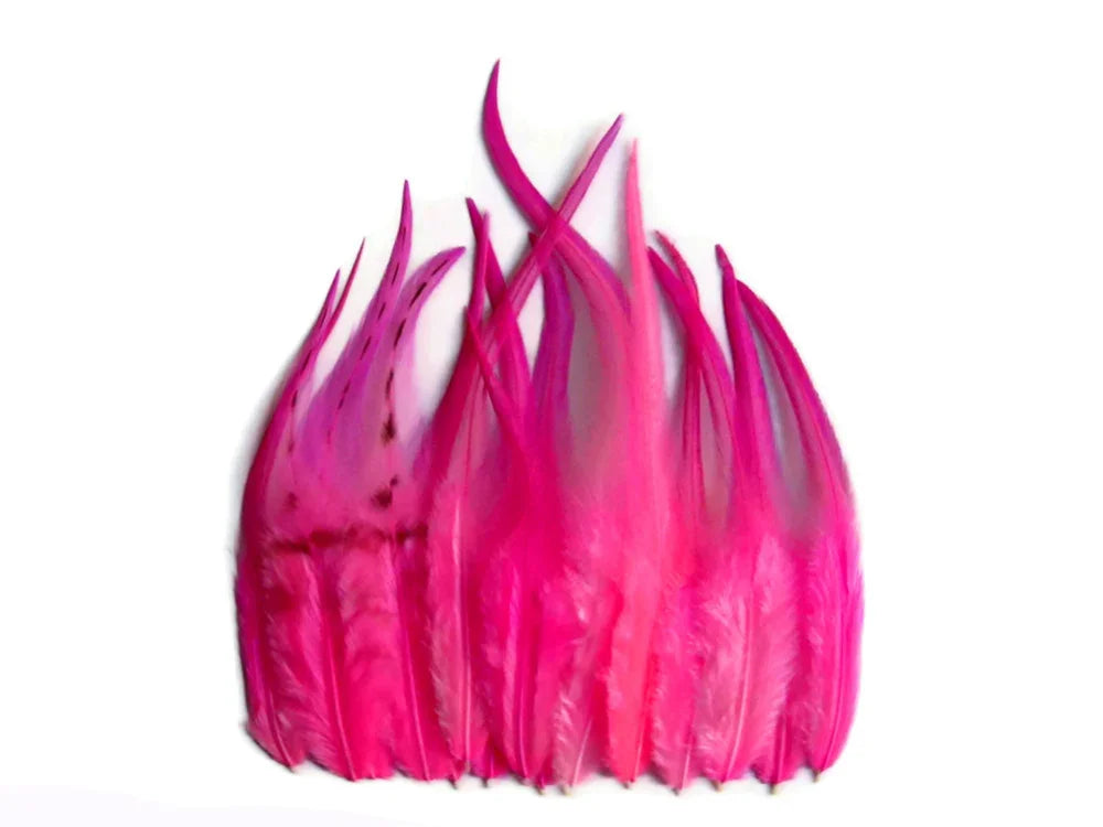 Vibrant hot pink dyed feathers for DIY crafts and fashion accessories on a white background.