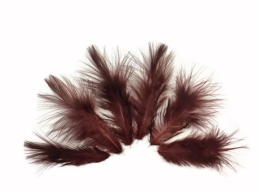 Deep burgundy maroon feathers for DIY crafts and fashion decor on a white background.