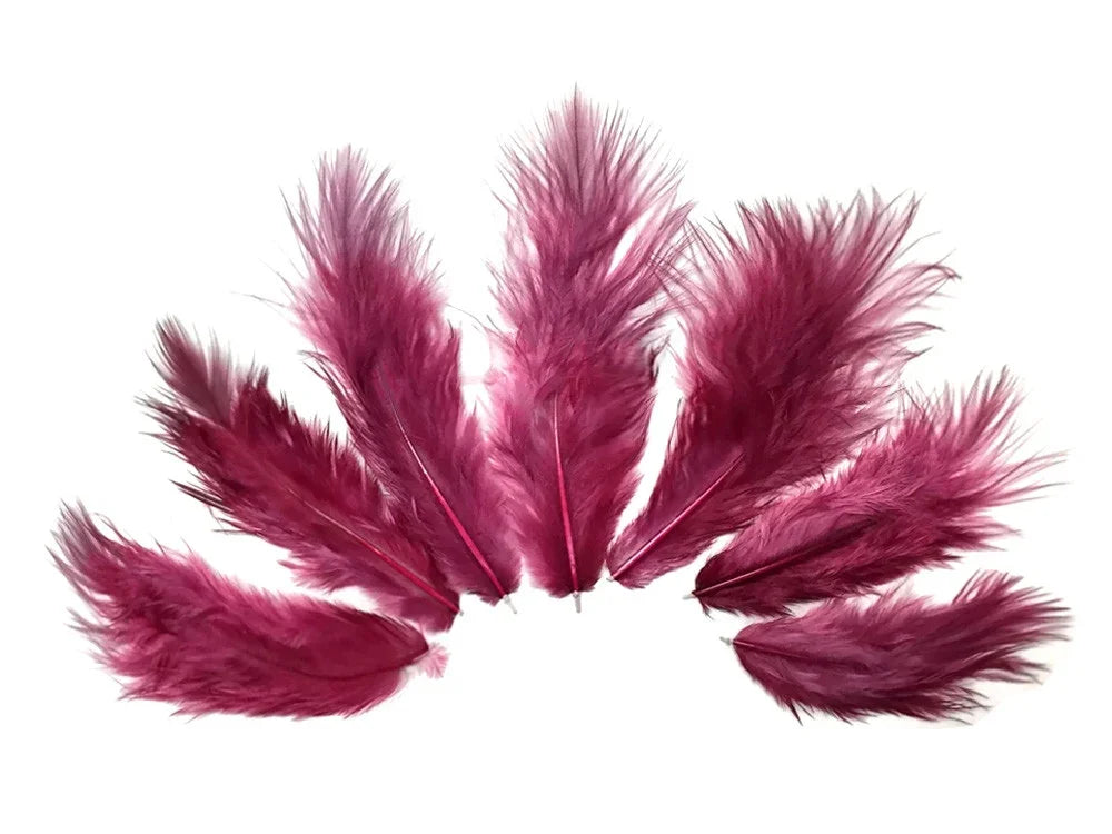 Vibrant magenta pink feathers arranged in a fan shape for DIY crafts and fashion decor.