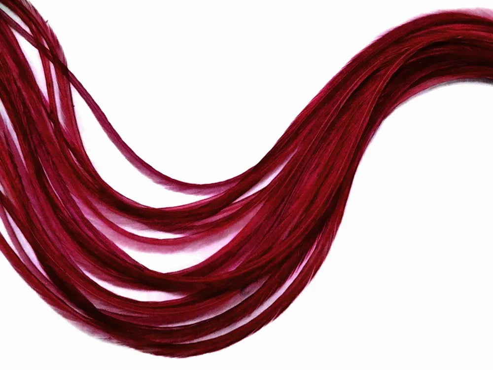 Vibrant burgundy red feathers for DIY crafts and fashion accessories on a white background.