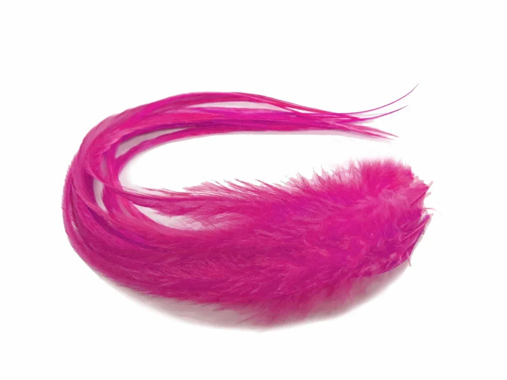 Vibrant hot pink feathers for DIY crafts and fashion decor on a white background.