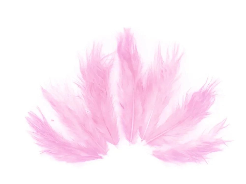 Soft pink ostrich feathers arranged in a fan shape for DIY crafts and fashion decor.