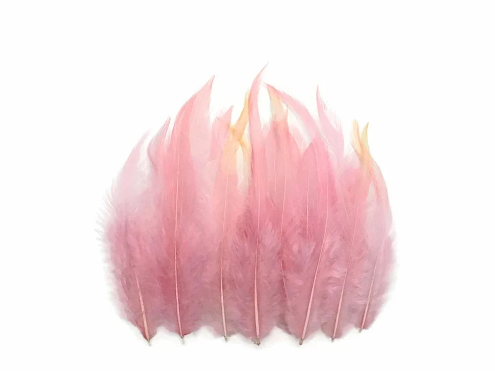 Soft pink ostrich feathers for DIY crafts and fashion accessories on a white background.