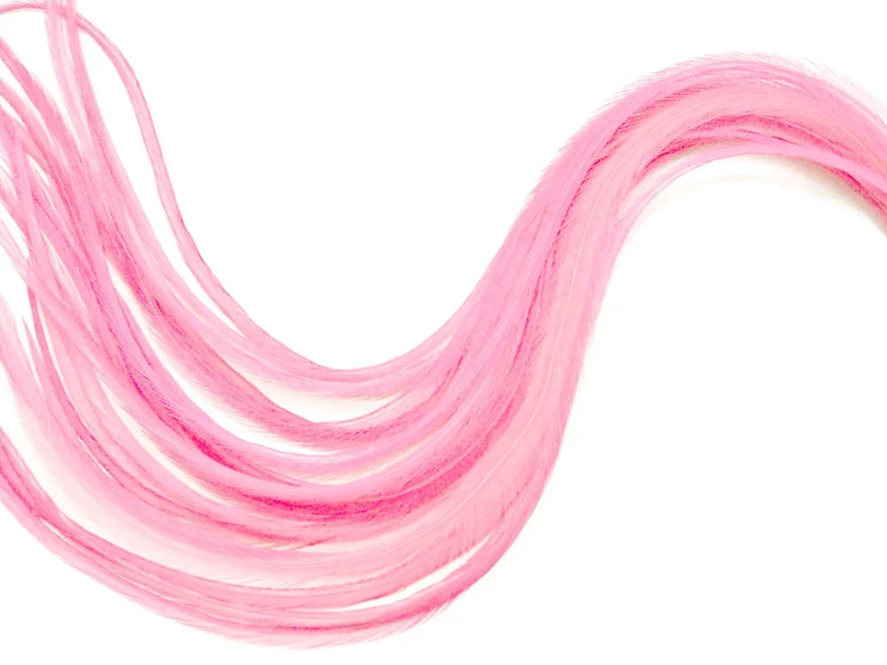 Vibrant pink craft feathers arranged in a curved shape on a white background.