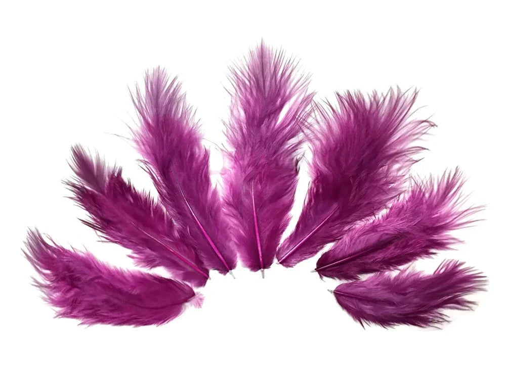 Vibrant purple craft feathers arranged in a semi-circle on a white background.