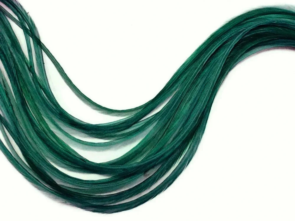Bundle of long, dyed emerald green feathers for crafts and fashion on a white background