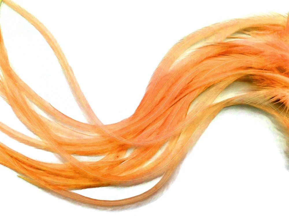 Long flowing peach-colored craft feathers for DIY fashion and decor accessories.