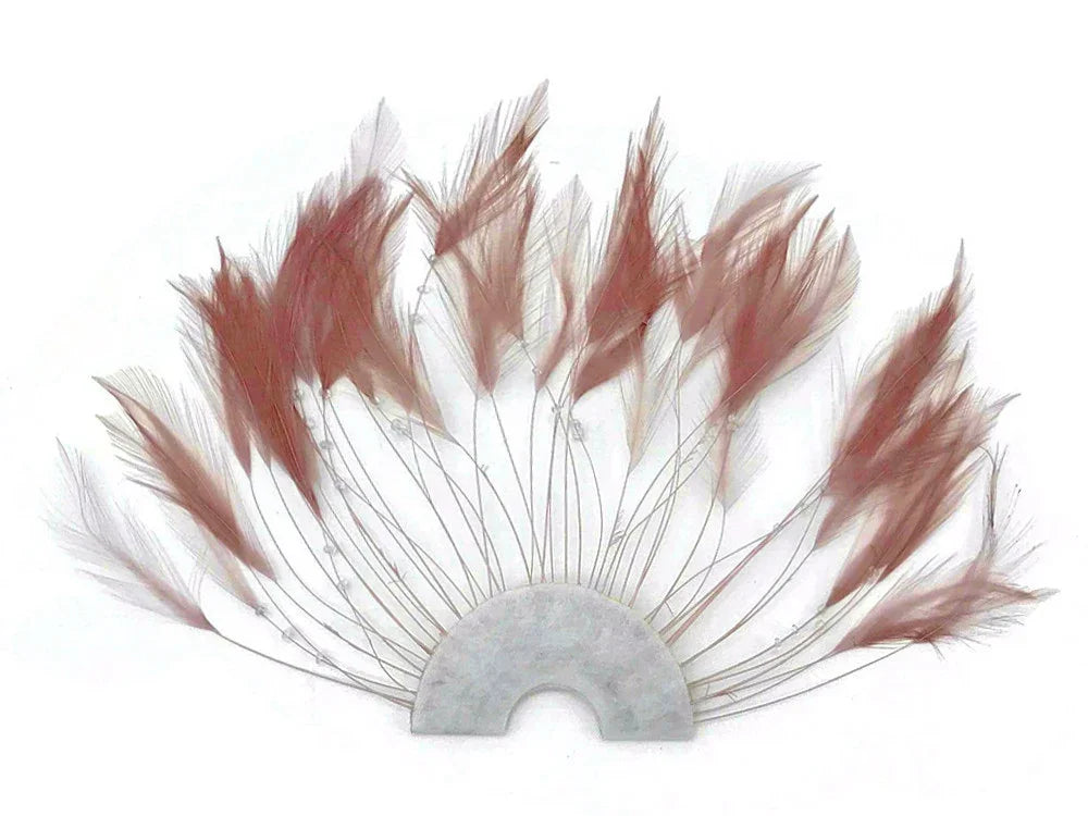 Dusty rose pink decorative feathers arranged in a semi-circle fan shape for DIY crafts.