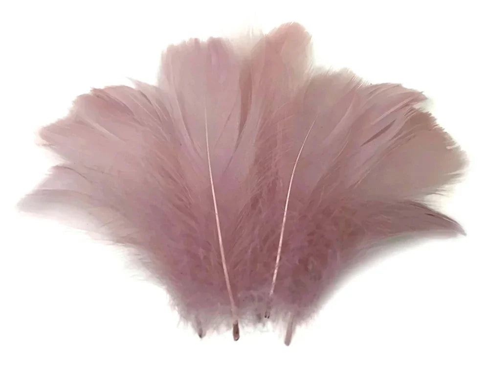 Soft dusty pink feathers for DIY crafts, fashion accessories, and décor.