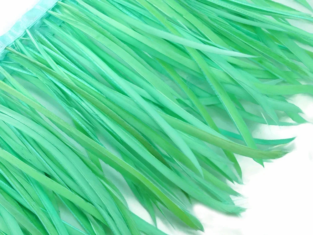 Vibrant mint green feather trim for DIY fashion and craft projects.
