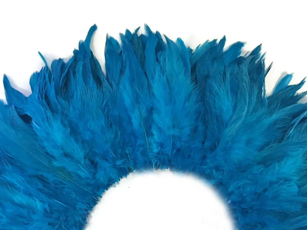 Vibrant blue decorative feathers arranged in a semi-circle for crafts and fashion DIY.