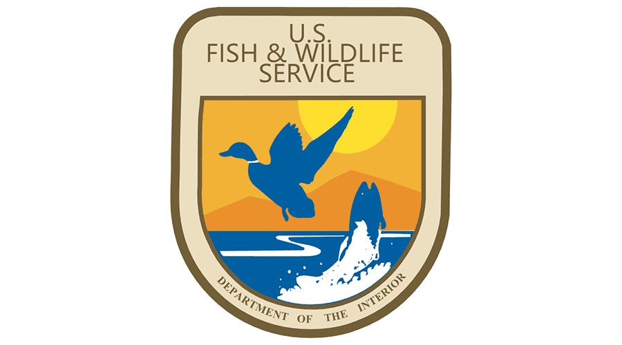 U.S. Fish & Wildlife Service official emblem with a blue duck silhouette flying over water.