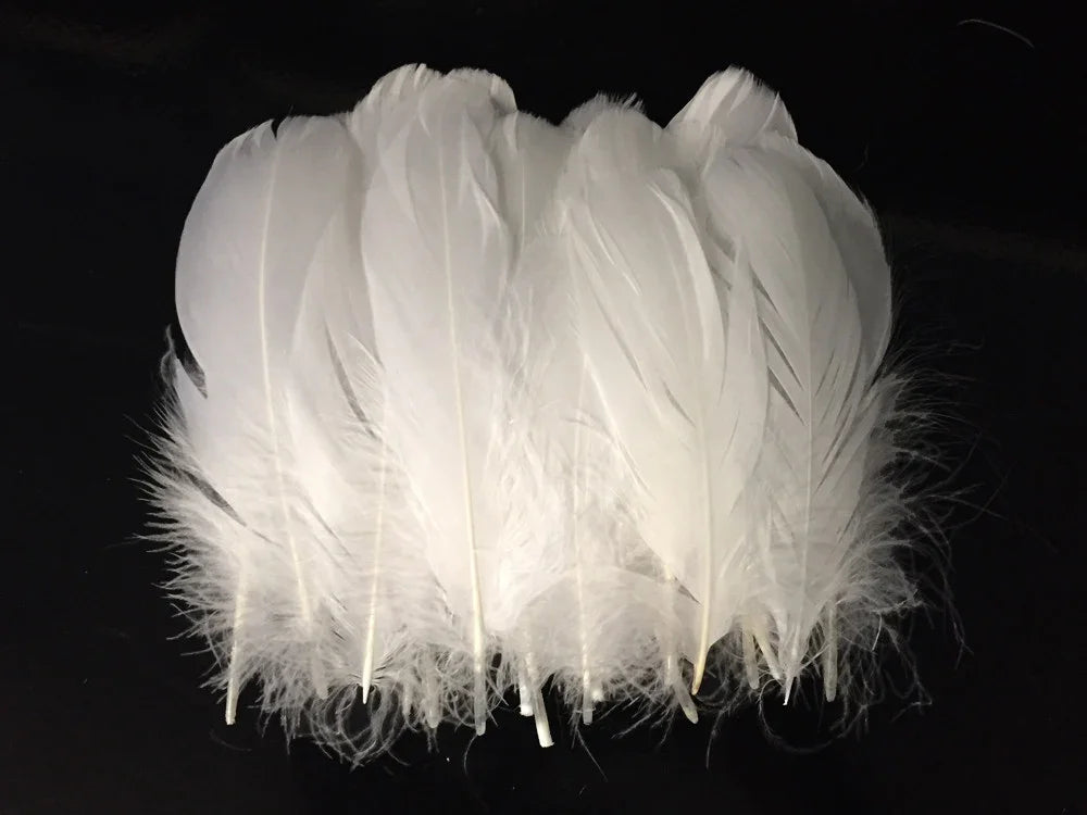 Soft white craft feathers for DIY fashion and décor accessories on a black background.