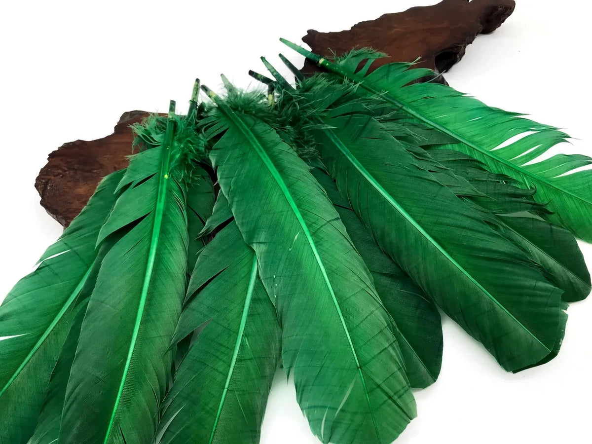 Vibrant green craft feathers arranged on a dark wood base for DIY fashion and decor.