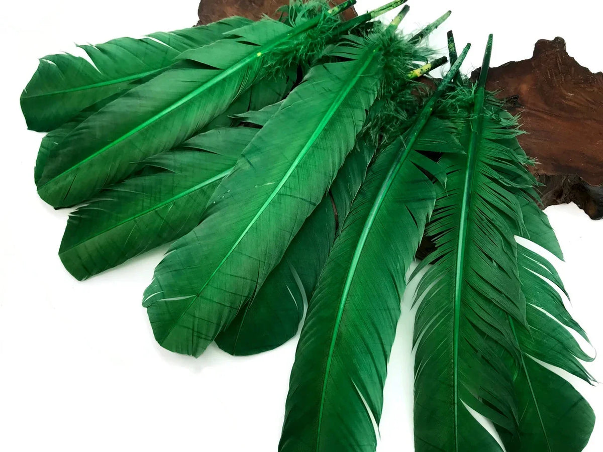 Vibrant green craft feathers arranged on a dark wood background for DIY fashion and decor.