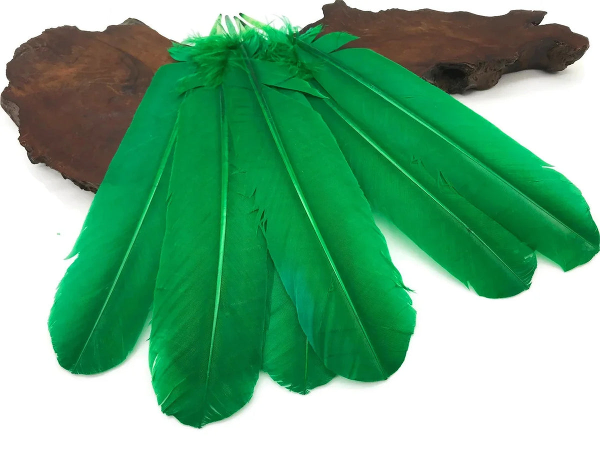 Vibrant green craft feathers arranged on a natural wood base for DIY decor and fashion.