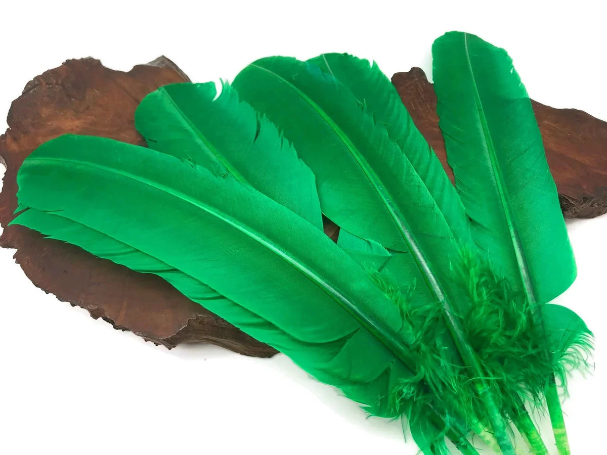Vibrant green craft feathers displayed on a rustic wooden base for DIY fashion and decor.