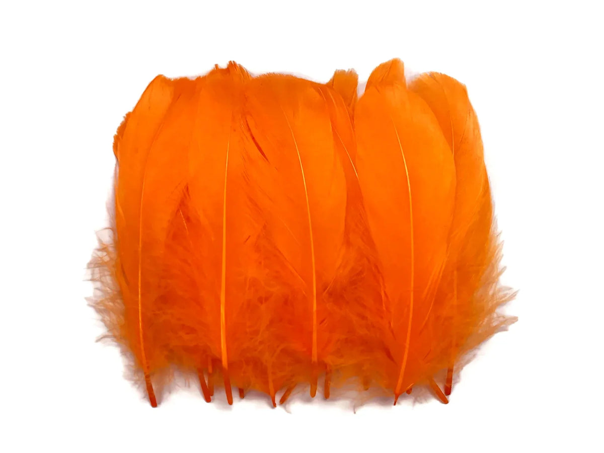 Bright orange goose nagoire feathers with rounded tips and soft bases on white.