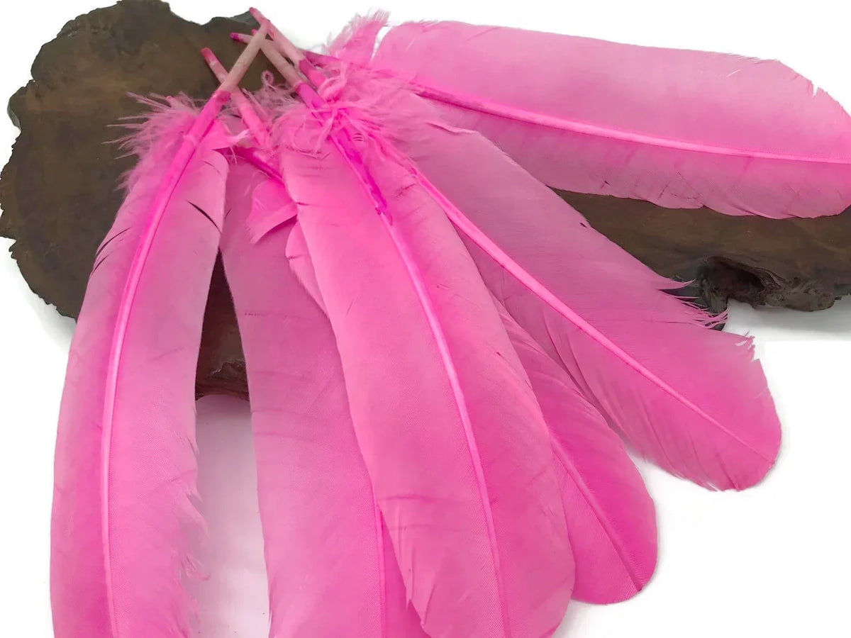 Vibrant pink dyed craft feathers for DIY fashion and décor projects.